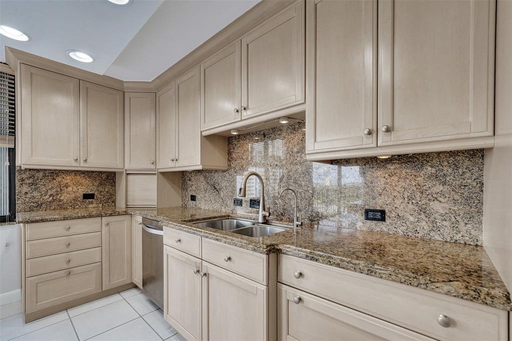 936 Intracoastal Drive, Unit 12C Fort Lauderdale, FL 33304 - Photo 38 of 65 a kitchen with granite countertop white cabinets and sink