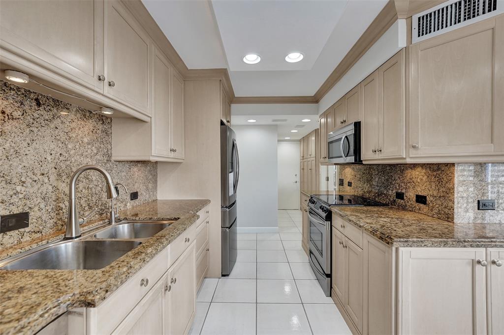936 Intracoastal Drive, Unit 12C Fort Lauderdale, FL 33304 - Photo 40 of 65 a kitchen with stainless steel appliances granite countertop a sink stove refrigerator and cabinets