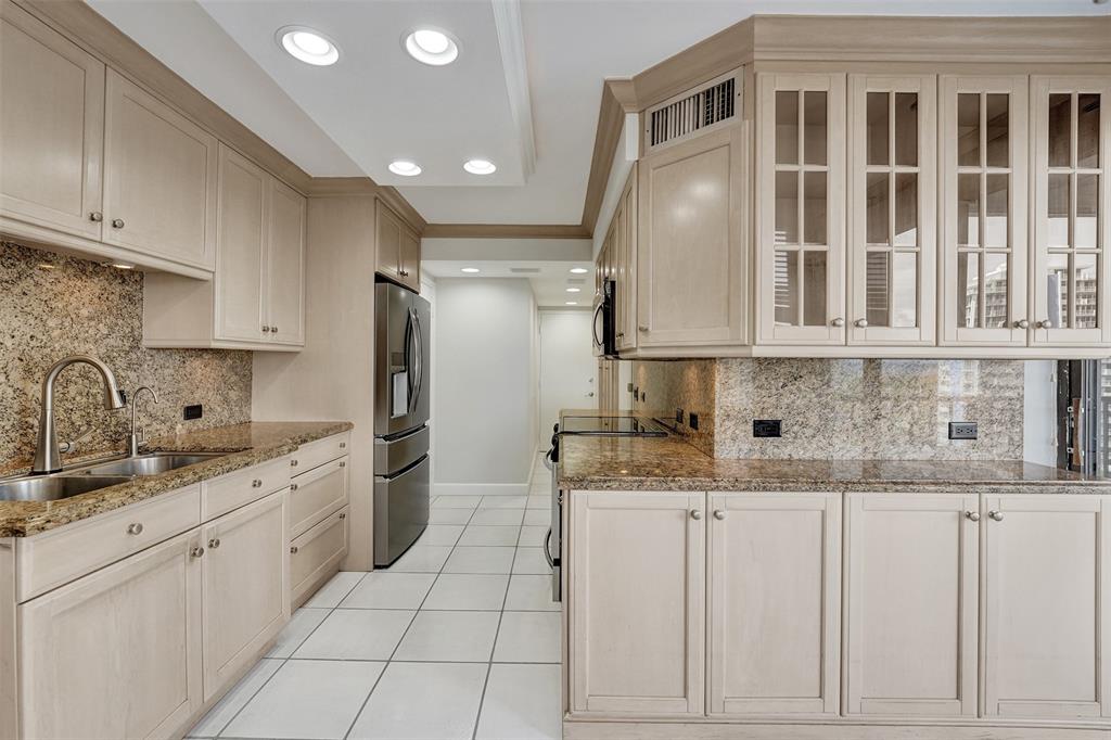 936 Intracoastal Drive, Unit 12C Fort Lauderdale, FL 33304 - Photo 42 of 65 a kitchen with granite countertop a sink stainless steel appliances and cabinets
