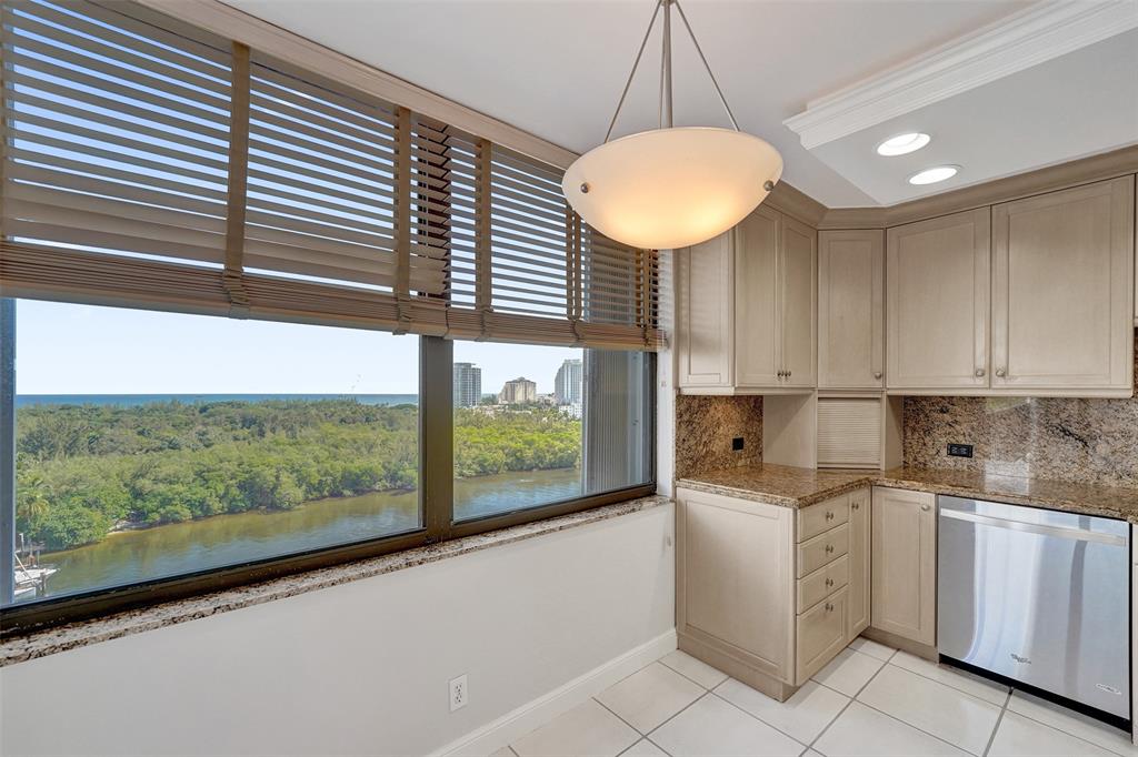 936 Intracoastal Drive, Unit 12C Fort Lauderdale, FL 33304 - Photo 44 of 65 a kitchen with white cabinets a sink and a window