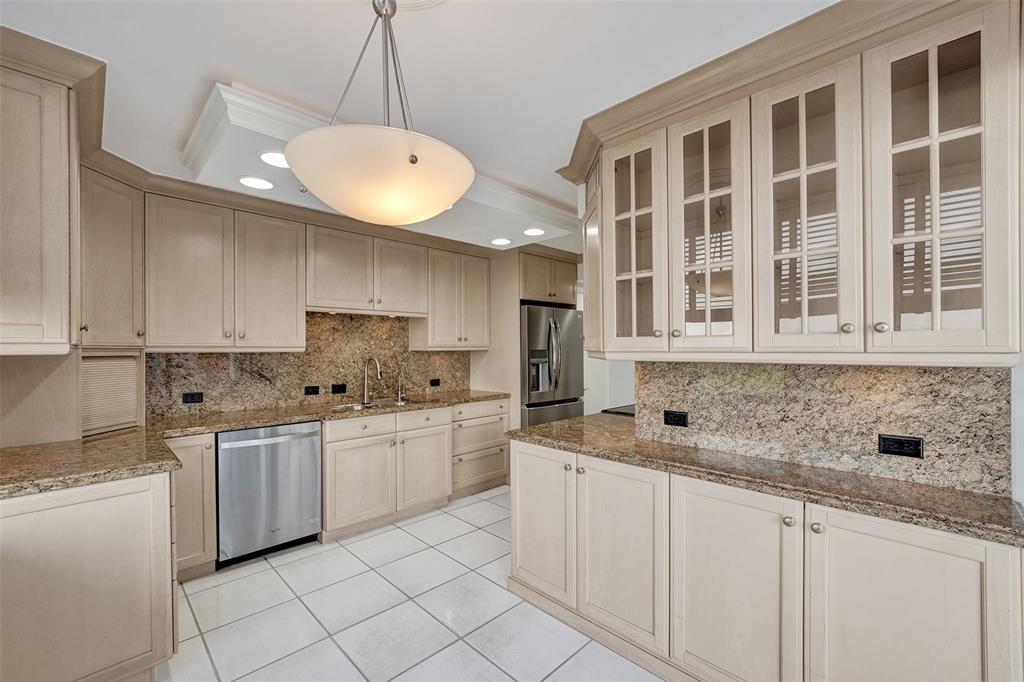 936 Intracoastal Drive, Unit 12C Fort Lauderdale, FL 33304 - Photo 45 of 65 a kitchen that has a lot of white cabinets and stainless steel appliances