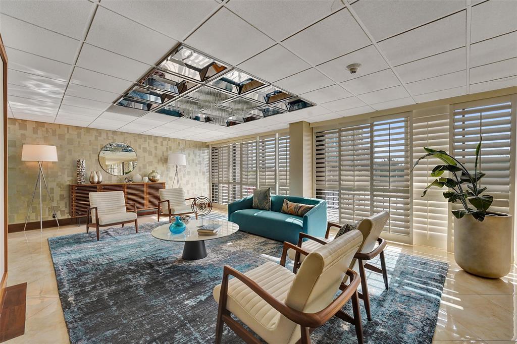 936 Intracoastal Drive, Unit 12C Fort Lauderdale, FL 33304 - Photo 59 of 65 a living room with furniture and a chandelier