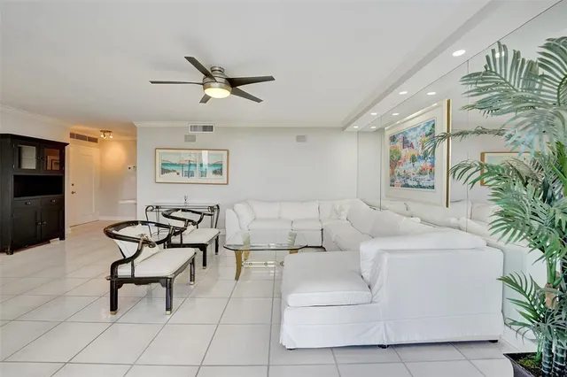 a dining room with chandelier fan and glass door