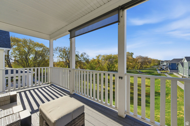 1038 South Old Towne Road Layton, UT 84041 - Photo 2 of 39 Covered outdoor balcony featuring composite decking, white railing, and a retractable shade