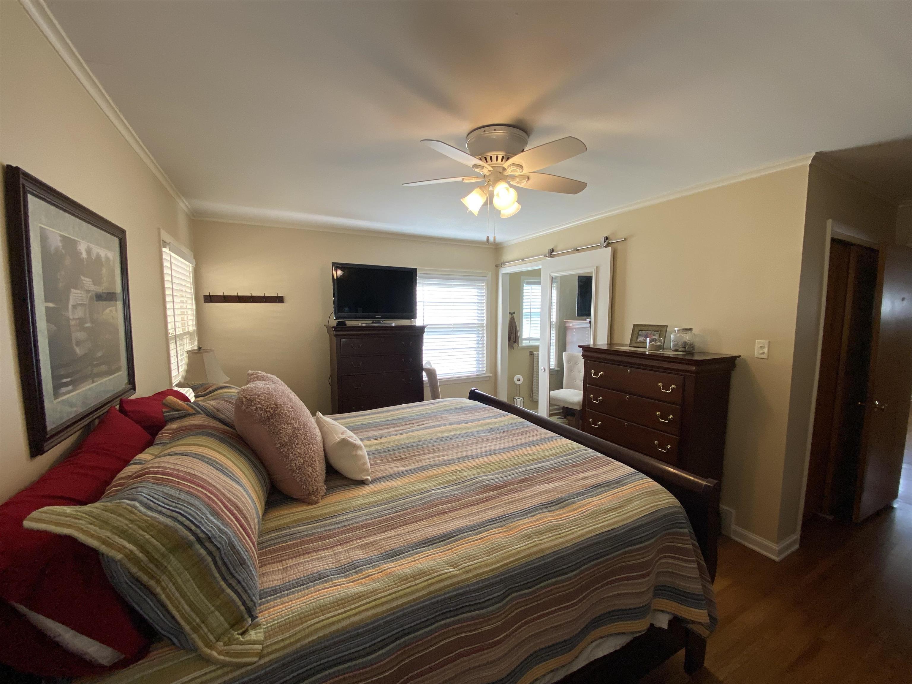 5111 Mason Road Memphis, TN 38117 - Photo 21 of 23 a bedroom with a bed and a chandelier
