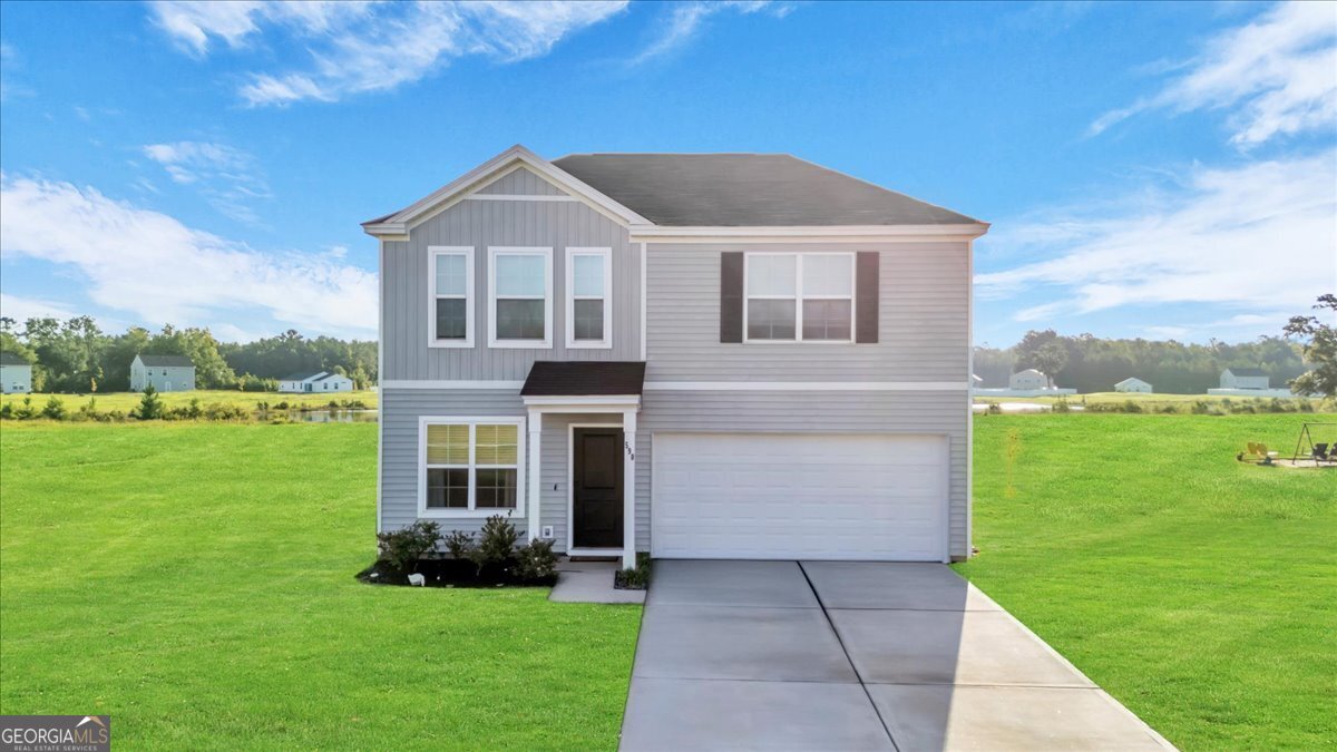 590 Wilkins Road Midway, GA 31320 - Photo 1 of 62 a front view of a house with a yard