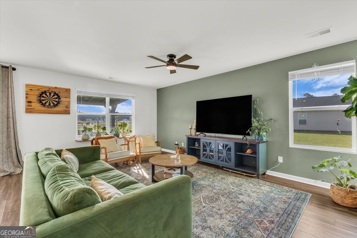 590 Wilkins Road Midway, GA 31320 - Photo 12 of 62 a living room with furniture and a flat screen tv