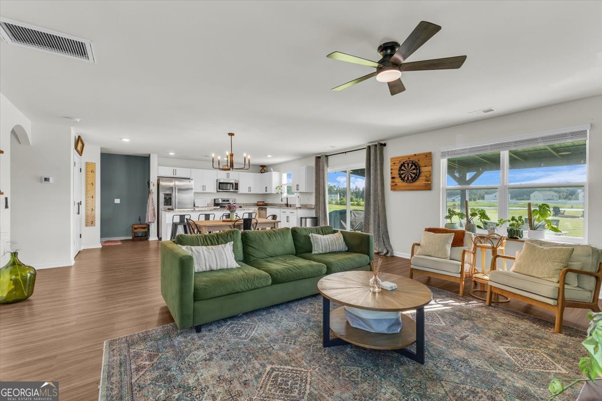 590 Wilkins Road Midway, GA 31320 - Photo 13 of 62 a living room with furniture and a large window