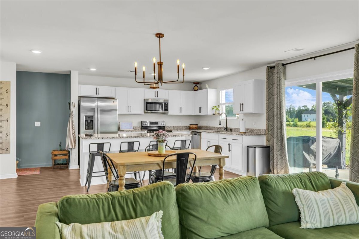 590 Wilkins Road Midway, GA 31320 - Photo 14 of 62 a living room kitchen with a couch and a view of kitchen appliances