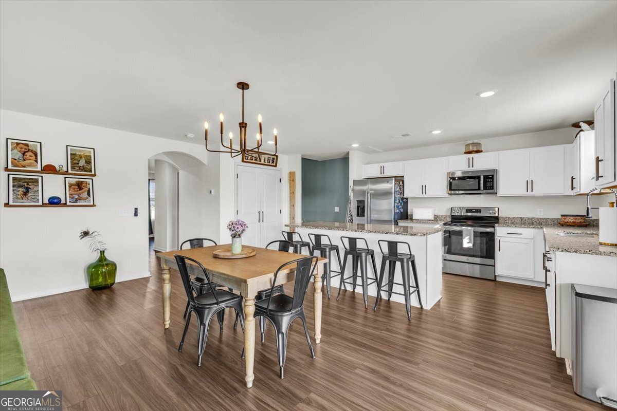 590 Wilkins Road Midway, GA 31320 - Photo 16 of 62 a view of a dining room with furniture window and wooden floor