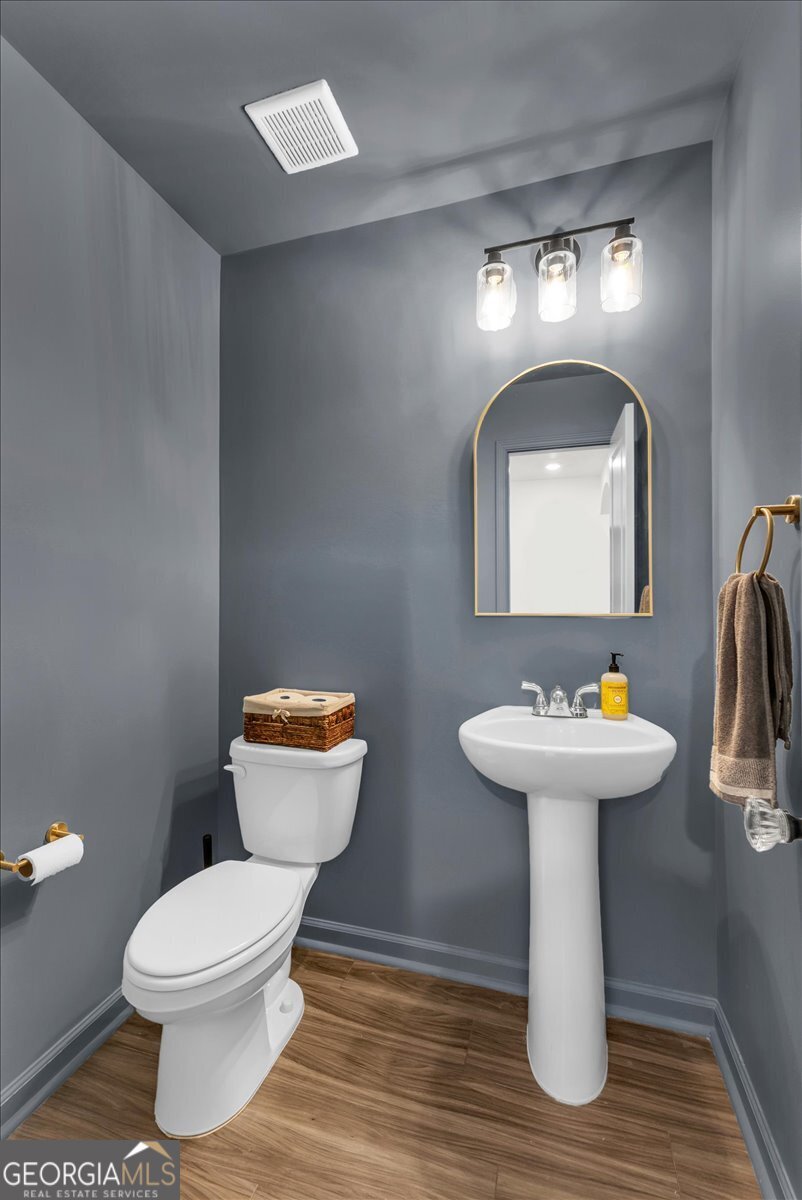 590 Wilkins Road Midway, GA 31320 - Photo 20 of 62 a bathroom with a toilet sink and mirror