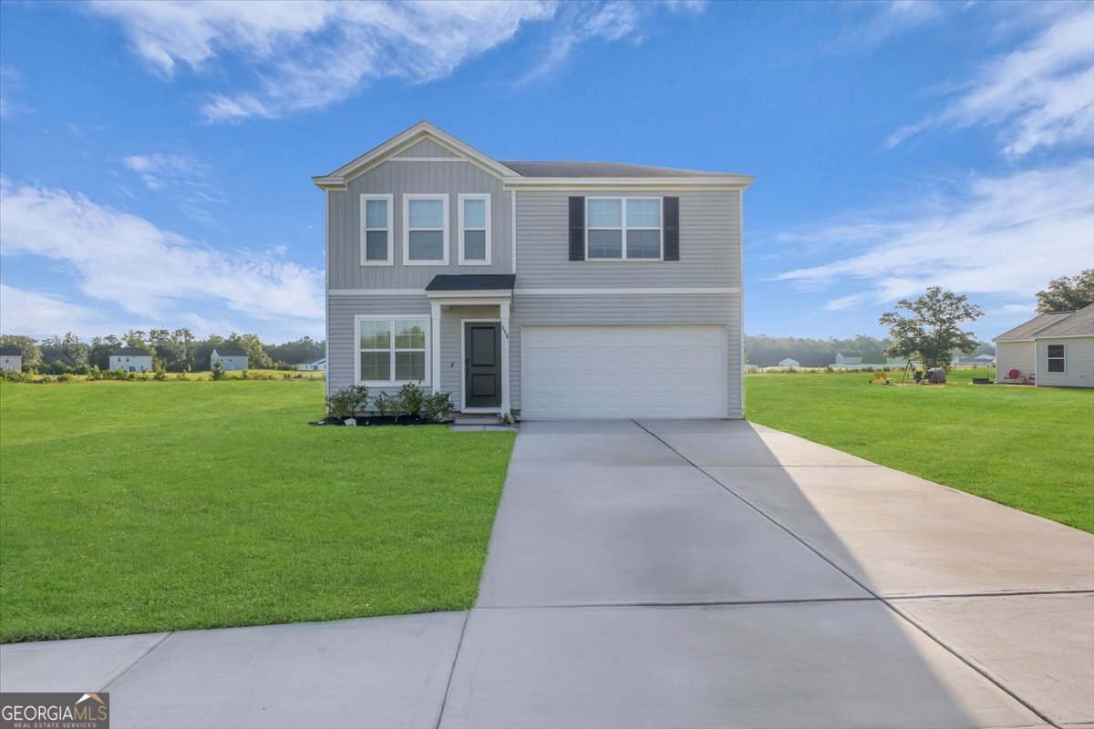 590 Wilkins Road Midway, GA 31320 - Photo 2 of 62 a front view of a house with garden