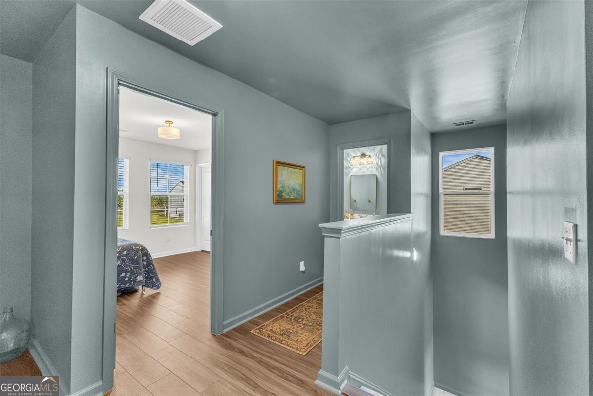 590 Wilkins Road Midway, GA 31320 - Photo 21 of 62 a view of a hallway with wooden floor fireplace and living room