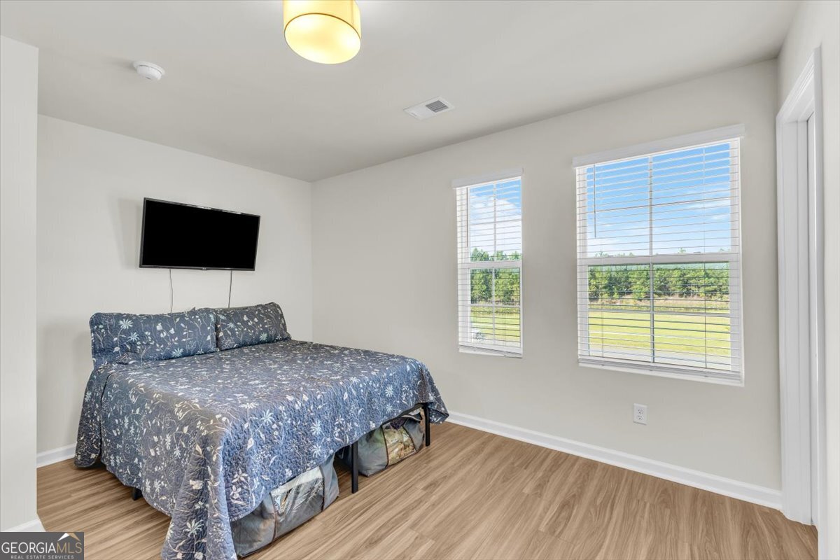 590 Wilkins Road Midway, GA 31320 - Photo 23 of 62 a bedroom with a bed and a flat screen tv