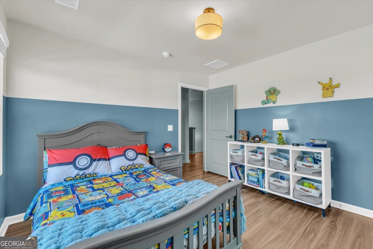 590 Wilkins Road Midway, GA 31320 - Photo 24 of 62 a bedroom with a bed and a dresser in it