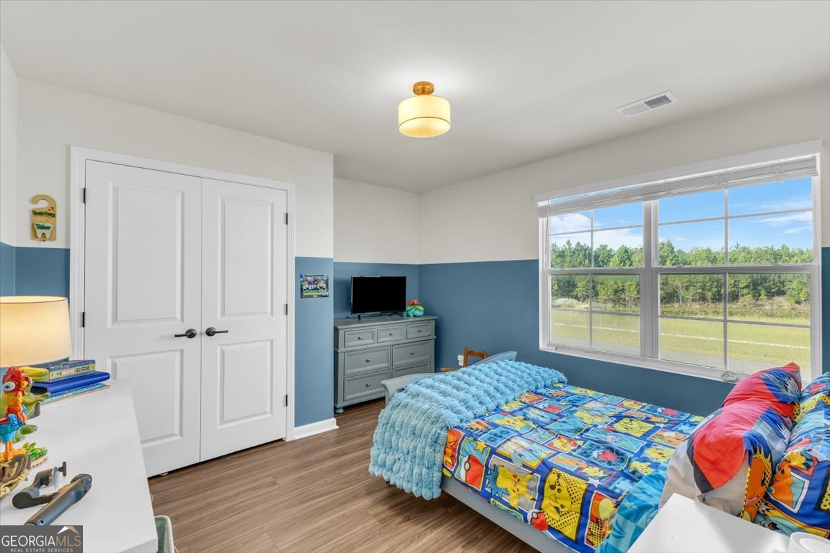 590 Wilkins Road Midway, GA 31320 - Photo 25 of 62 a bedroom with a bed and a window