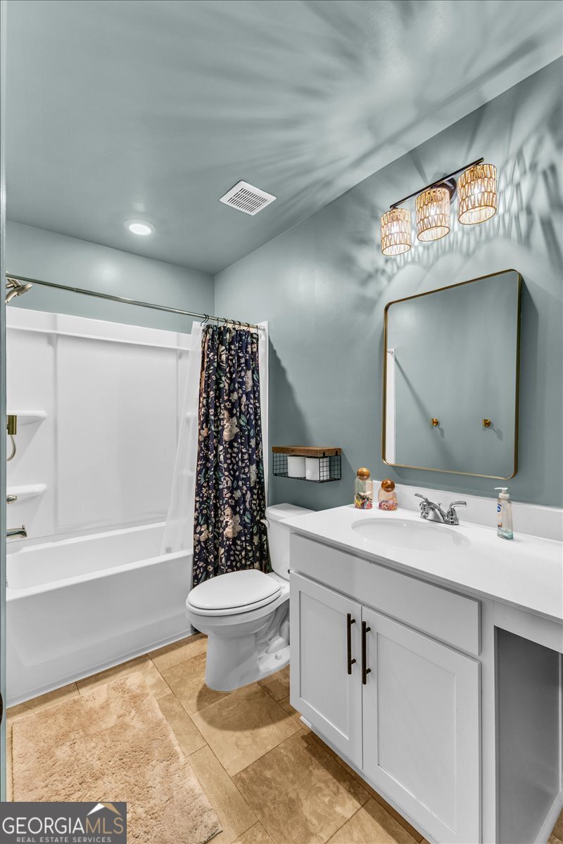 590 Wilkins Road Midway, GA 31320 - Photo 30 of 62 a bathroom with a sink toilet a mirror and bathtub