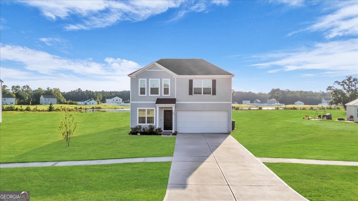 590 Wilkins Road Midway, GA 31320 - Photo 3 of 62 a front view of a house with a yard table and chairs