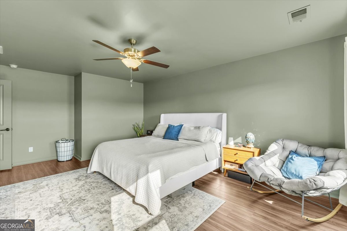 590 Wilkins Road Midway, GA 31320 - Photo 34 of 62 a bedroom with a bed and a potted plant