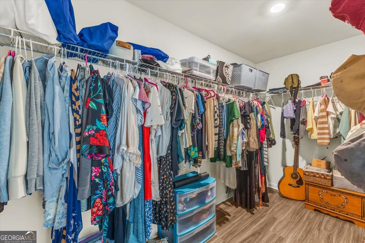 590 Wilkins Road Midway, GA 31320 - Photo 38 of 62 a view of walk in closet with clothes