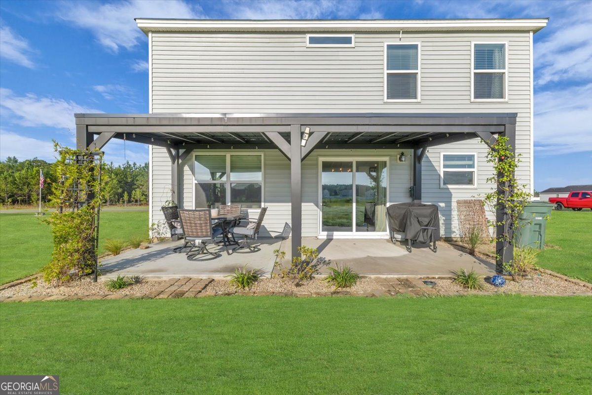 590 Wilkins Road Midway, GA 31320 - Photo 45 of 62 a view of a house with backyard porch and sitting area