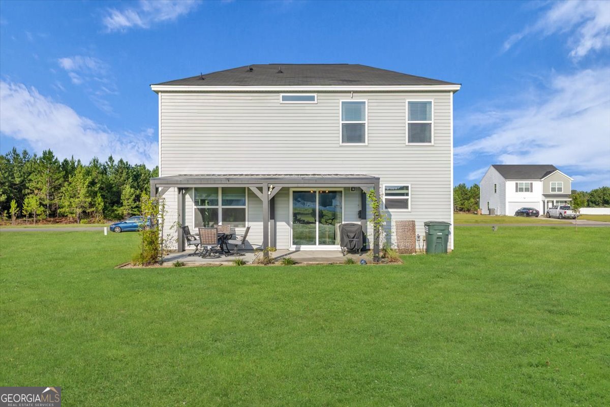 590 Wilkins Road Midway, GA 31320 - Photo 51 of 62 a front view of a house with a yard and sitting area