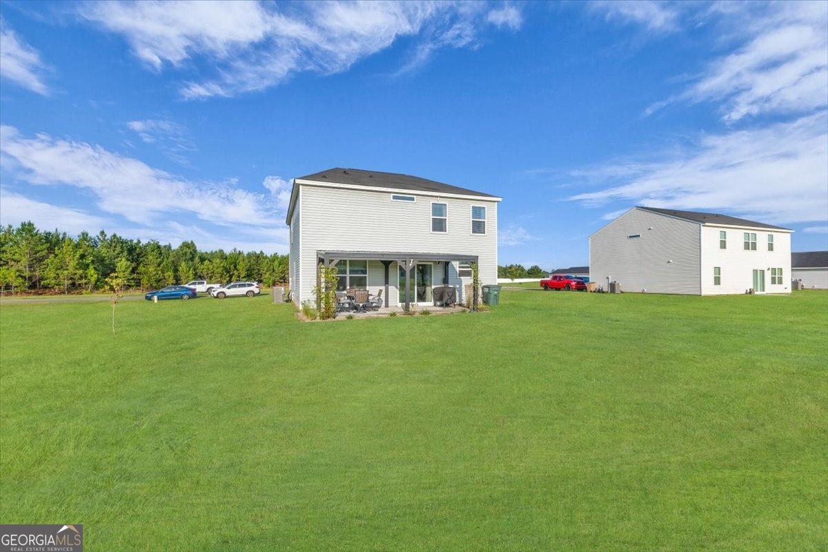590 Wilkins Road Midway, GA 31320 - Photo 52 of 62 a view of an house with backyard space and balcony