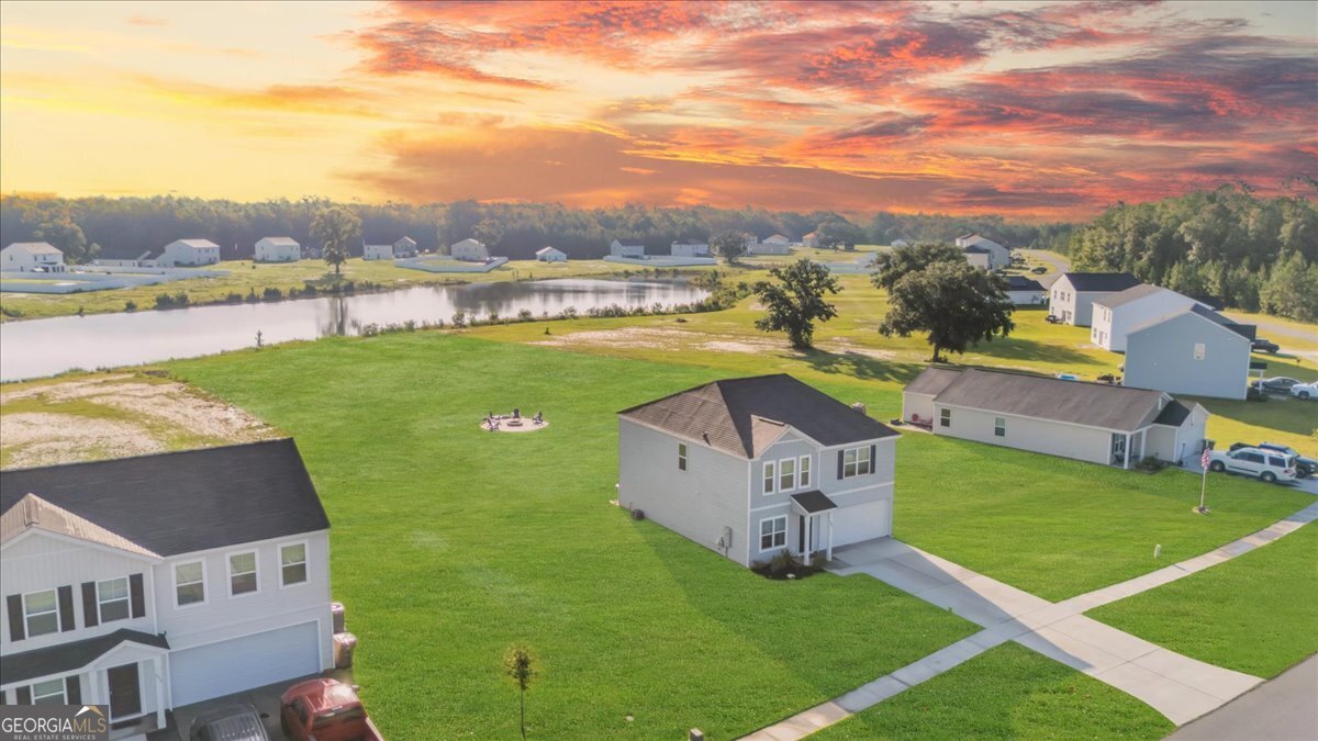 590 Wilkins Road Midway, GA 31320 - Photo 56 of 62 an aerial view of a house with pool garden and mountain view in back