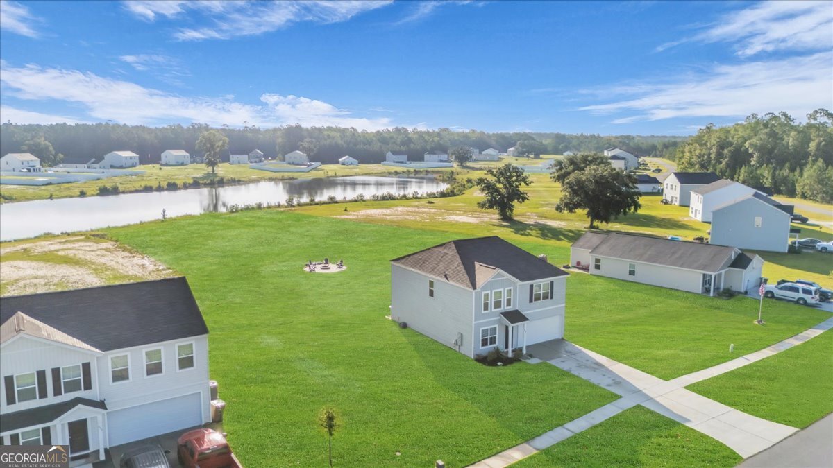 590 Wilkins Road Midway, GA 31320 - Photo 59 of 62 an aerial view of residential houses with outdoor space and swimming pool