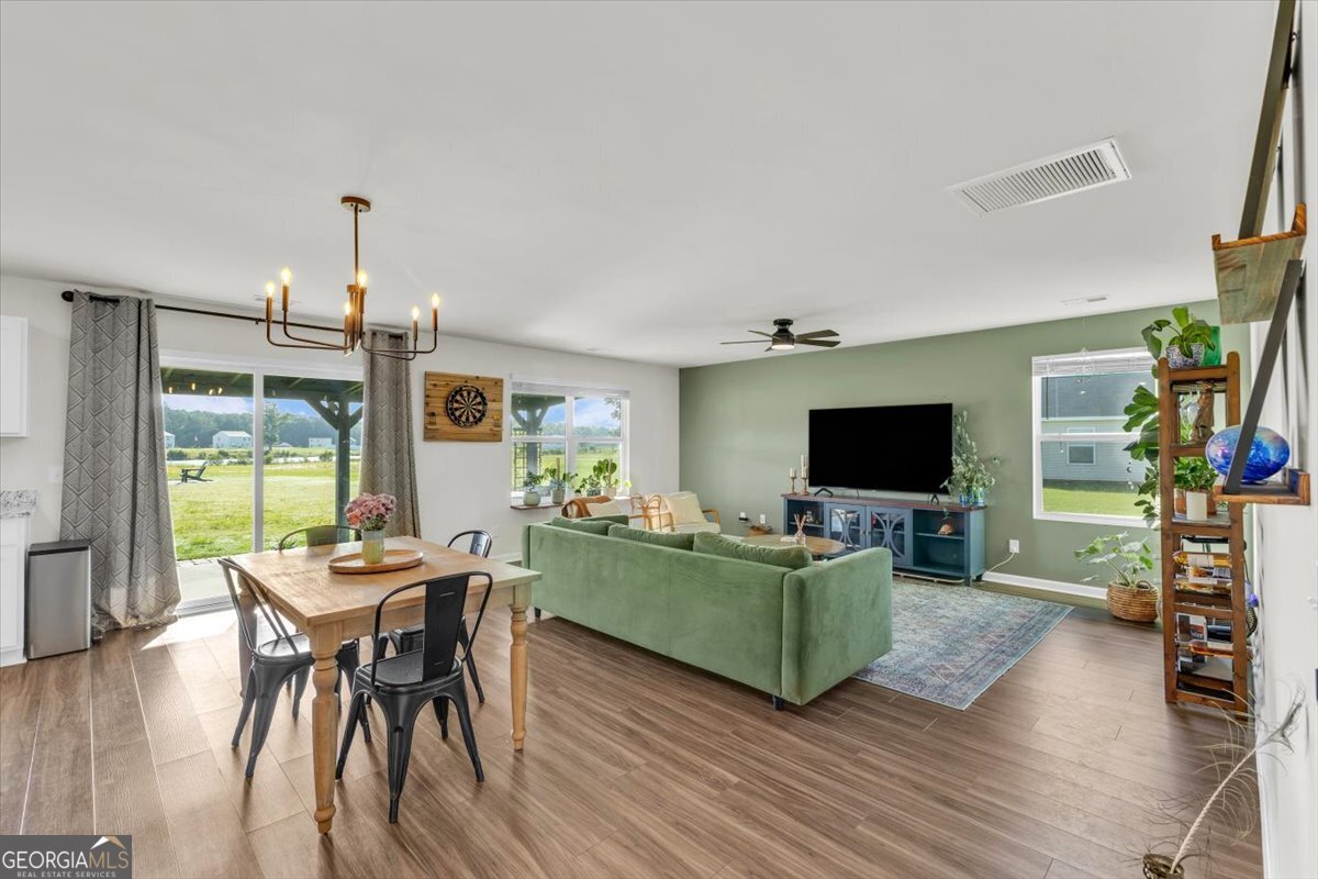 590 Wilkins Road Midway, GA 31320 - Photo 8 of 62 a living room with furniture and a flat screen tv