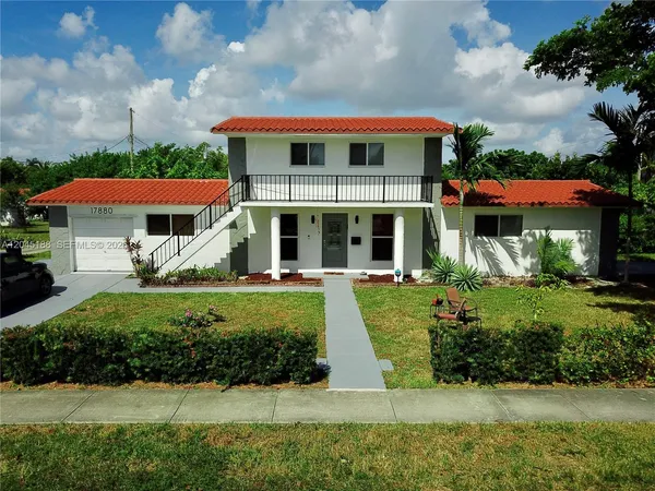 a front view of house with yard and green space