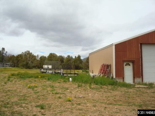 2271 Empire Road, Unit 24 Reno, NV 89521 - Photo 7 of 9 a backyard of apartments with large trees
