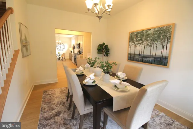 a view of a dining room with furniture and chandelier