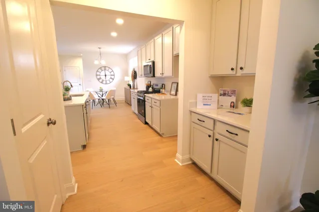 a kitchen with cabinets and wooden floor
