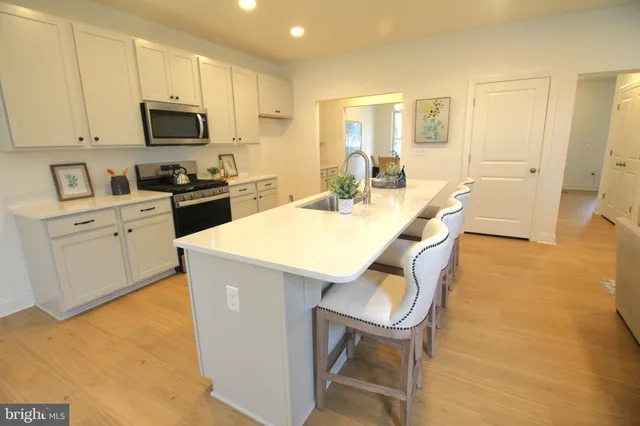 a kitchen with granite countertop a sink appliances and cabinets