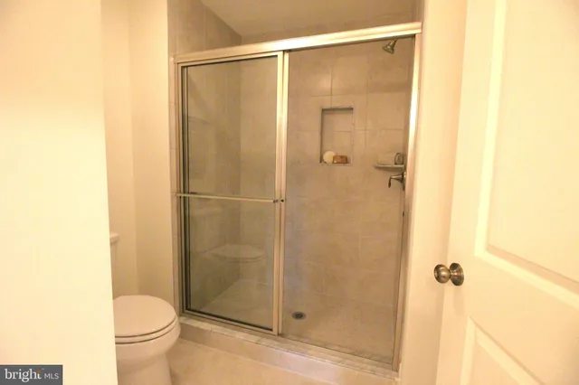 a bathroom with a glass shower door