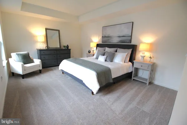 a bedroom with a bed and lamp