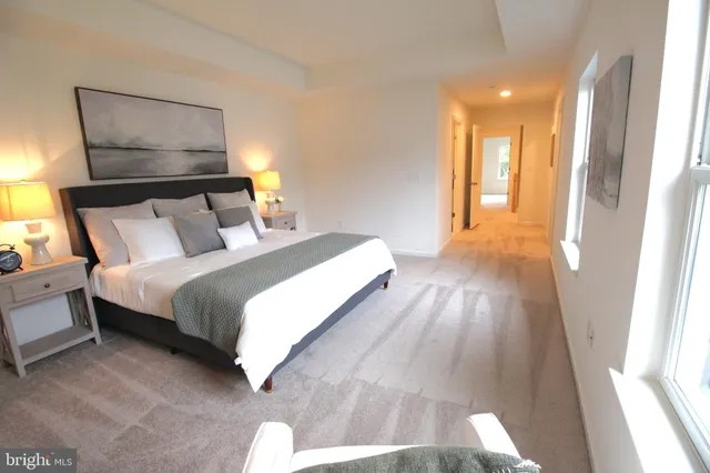 a bedroom with a bed and a large mirror