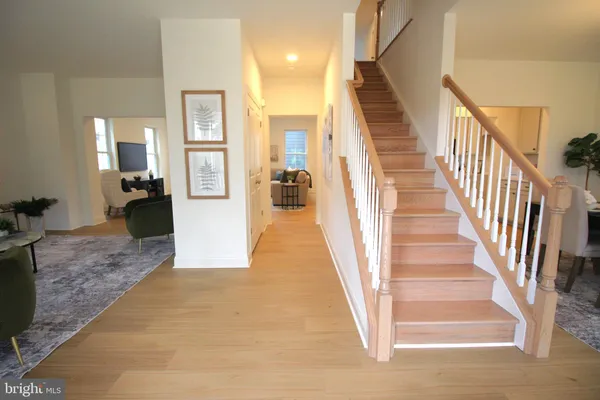 a view of entryway and hall with wooden floor
