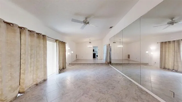 a view of an empty room with a fireplace and a window