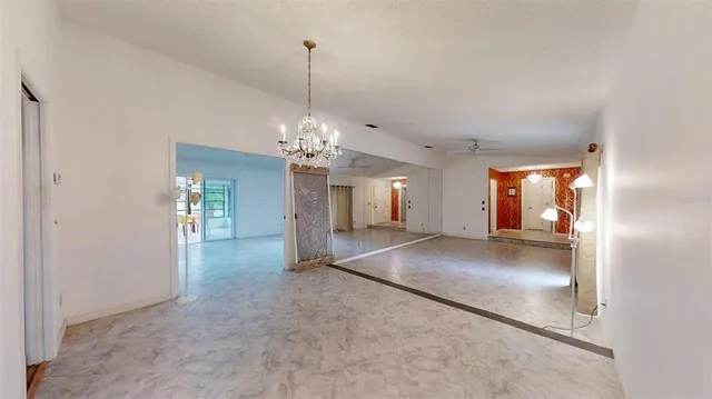 a view of an empty room with a fireplace and a window