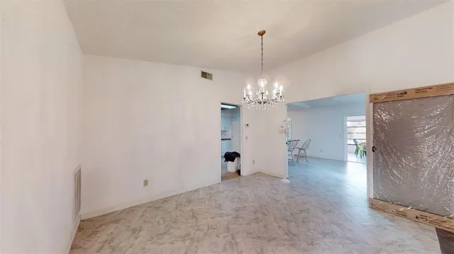 a kitchen with stainless steel appliances granite countertop a refrigerator stove oven and white cabinets