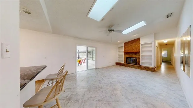 a kitchen with granite countertop white cabinets and a white stove top oven