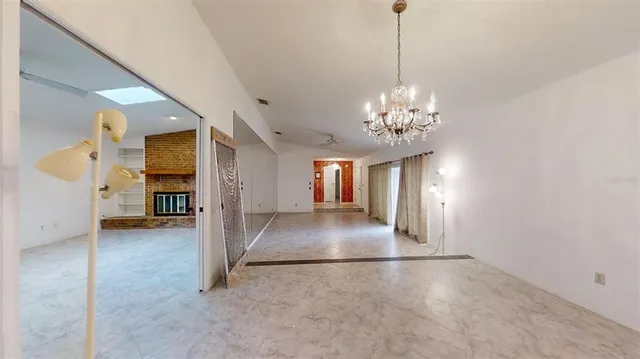 a kitchen with cabinets stainless steel appliances a sink and a window