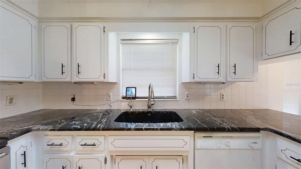 53 North Archwood Drive Inverness, FL 34450 - Photo 29 of 81 a kitchen with granite countertop white cabinets and a white stove top oven