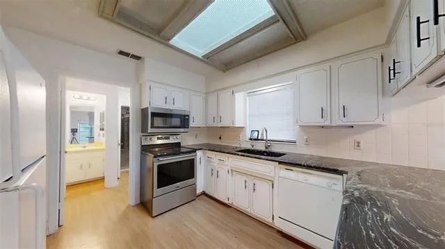 a view of an empty room with a fan