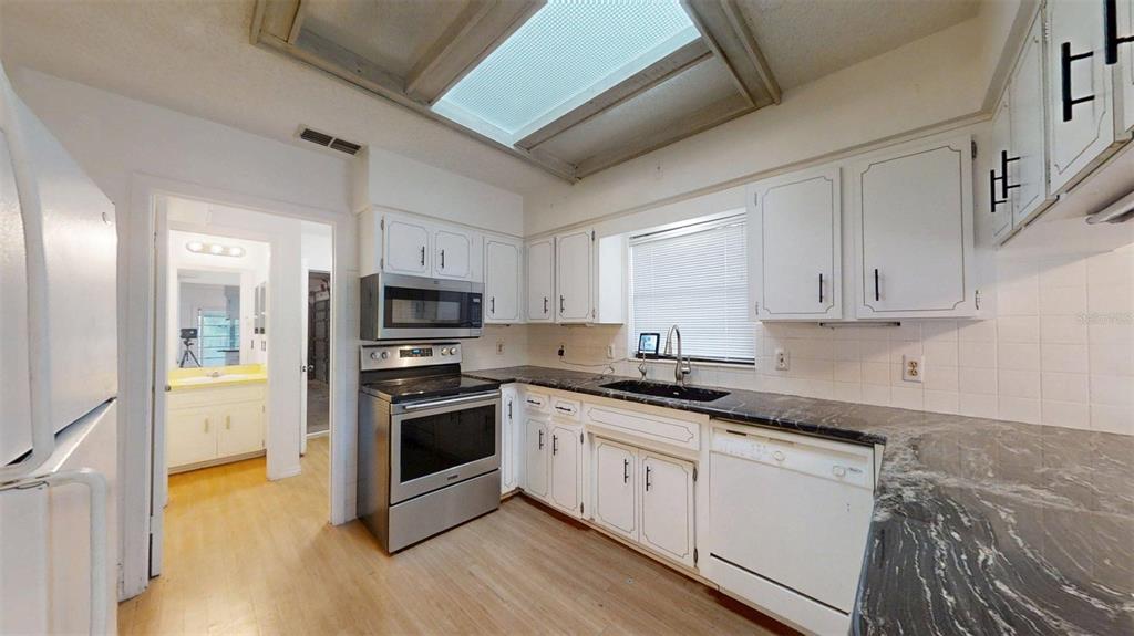 53 North Archwood Drive Inverness, FL 34450 - Photo 31 of 81 a kitchen with granite countertop a sink and steel appliances