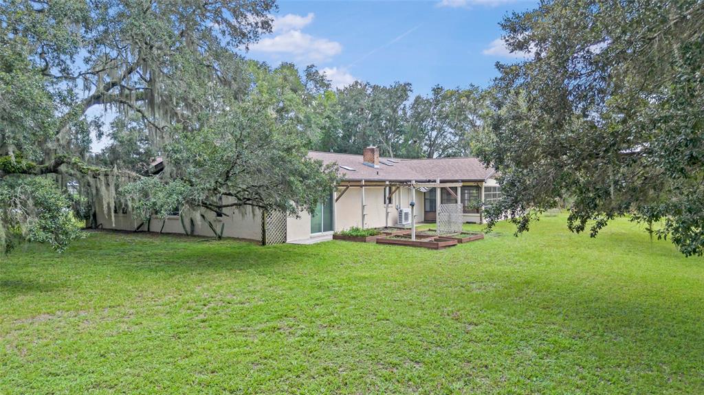 53 North Archwood Drive Inverness, FL 34450 - Photo 4 of 81 a view of a house with a yard porch and sitting area