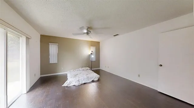 a view of a yard with wooden fence