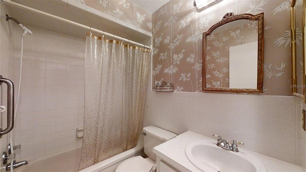 53 North Archwood Drive Inverness, FL 34450 - Photo 53 of 81 a bathroom with a sink a mirror and a shower